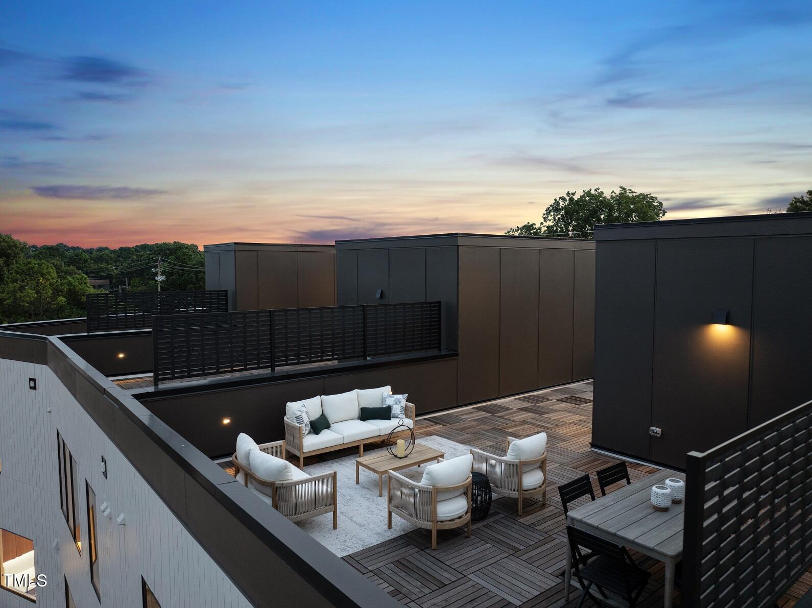 1303 Chamblee Hill Raleigh, NC 27608 - Photo 41 of 49 a roof deck with couches and wooden fence