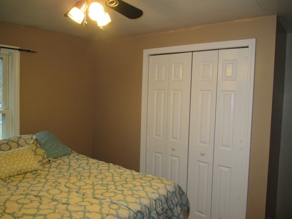 35 School House Road Phillipston, MA 01331 - Photo 14 of 32 a bedroom with a bed and a chandelier fan