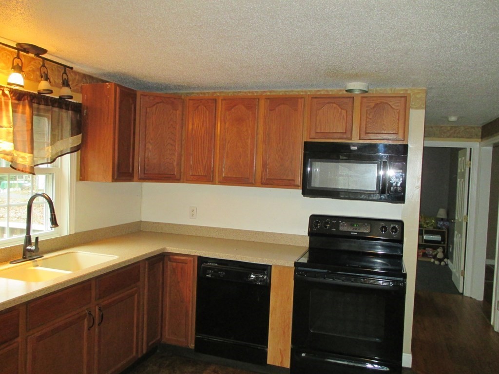 35 School House Road Phillipston, MA 01331 - Photo 7 of 32 a kitchen with a sink stove and microwave