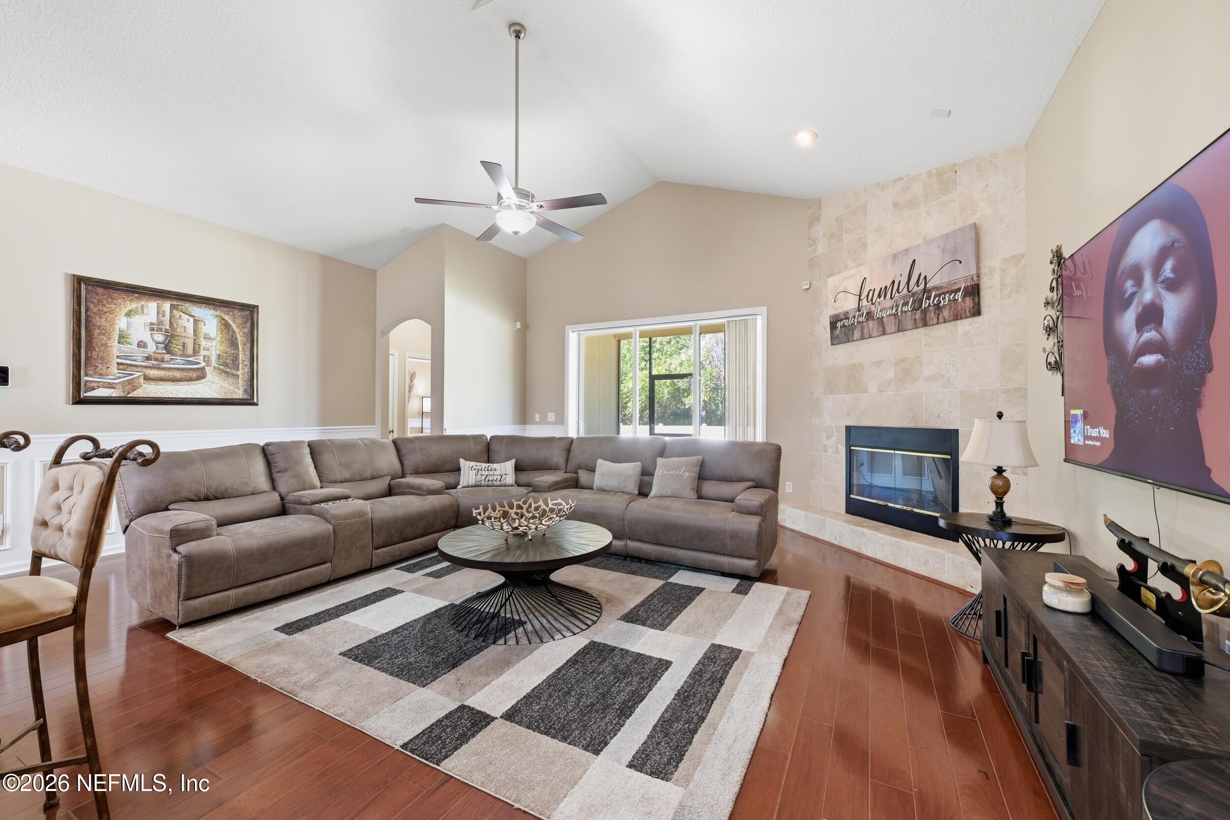 86178 Sand Hickory Trail Yulee, FL 32097 - Photo 7 of 23 a living room with furniture a fireplace and a chandelier
