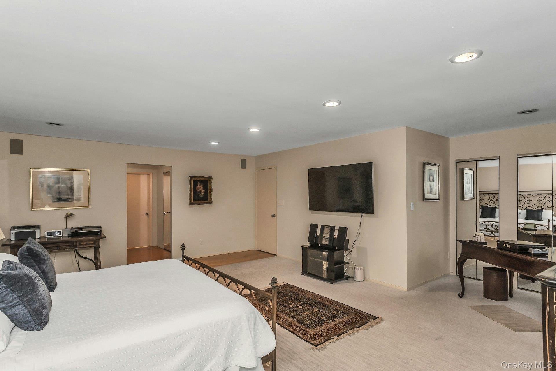 232 Linnet Court Manhasset, NY 11030 - Photo 12 of 28 a bedroom with a bed and a flat screen tv