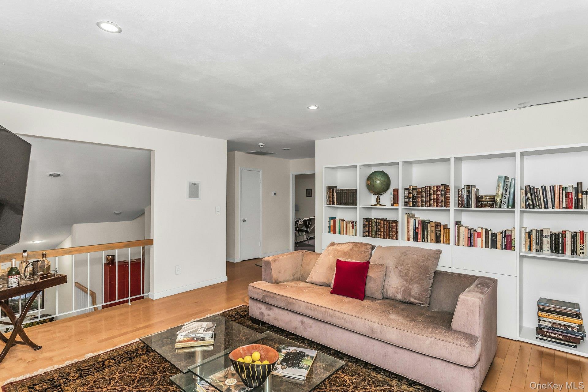 232 Linnet Court Manhasset, NY 11030 - Photo 16 of 28 a living room with furniture and a book shelf