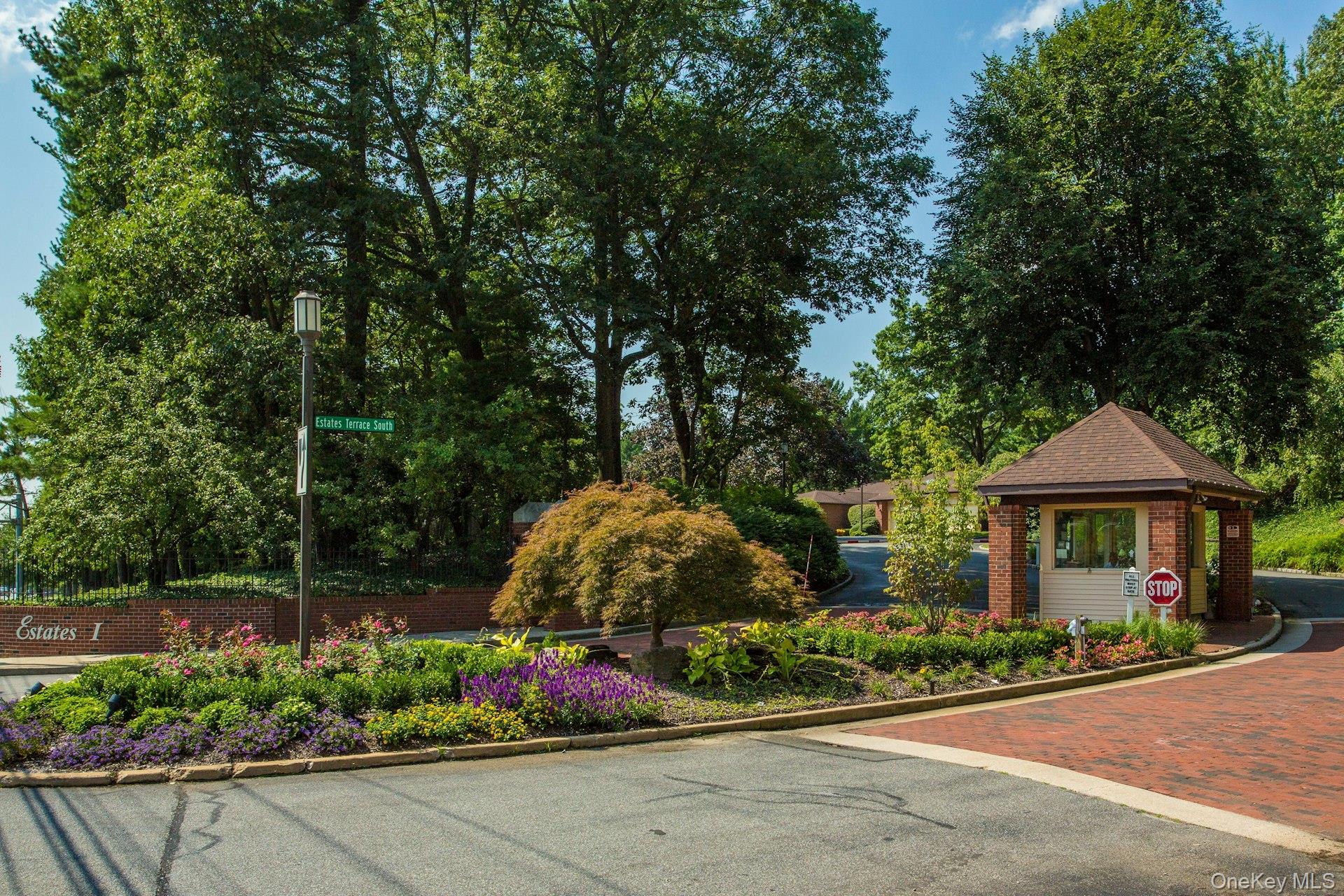 232 Linnet Court Manhasset, NY 11030 - Photo 21 of 28 a view of a garden with flowers and a bench