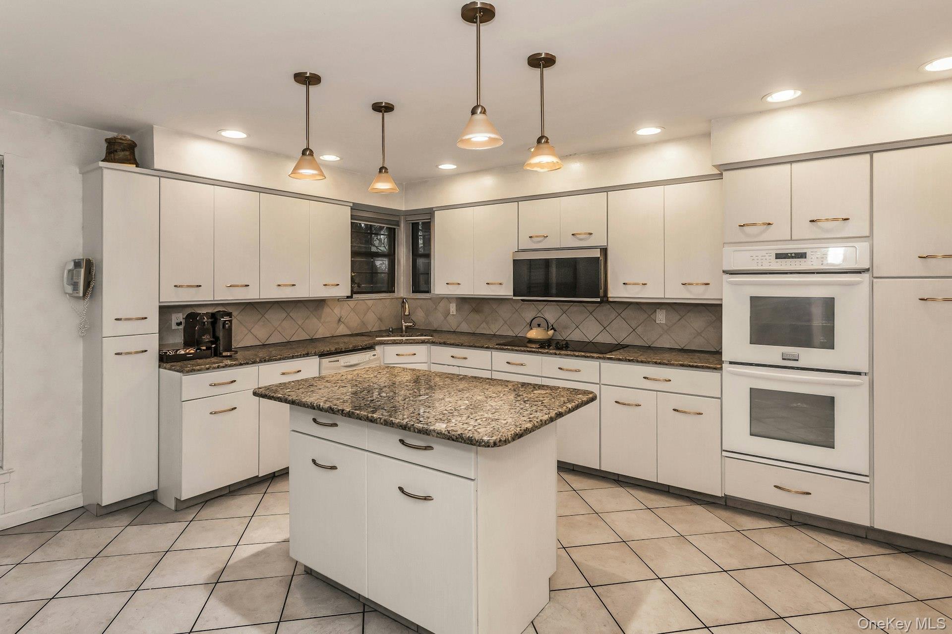 232 Linnet Court Manhasset, NY 11030 - Photo 8 of 28 a kitchen with white cabinets appliances and a sink
