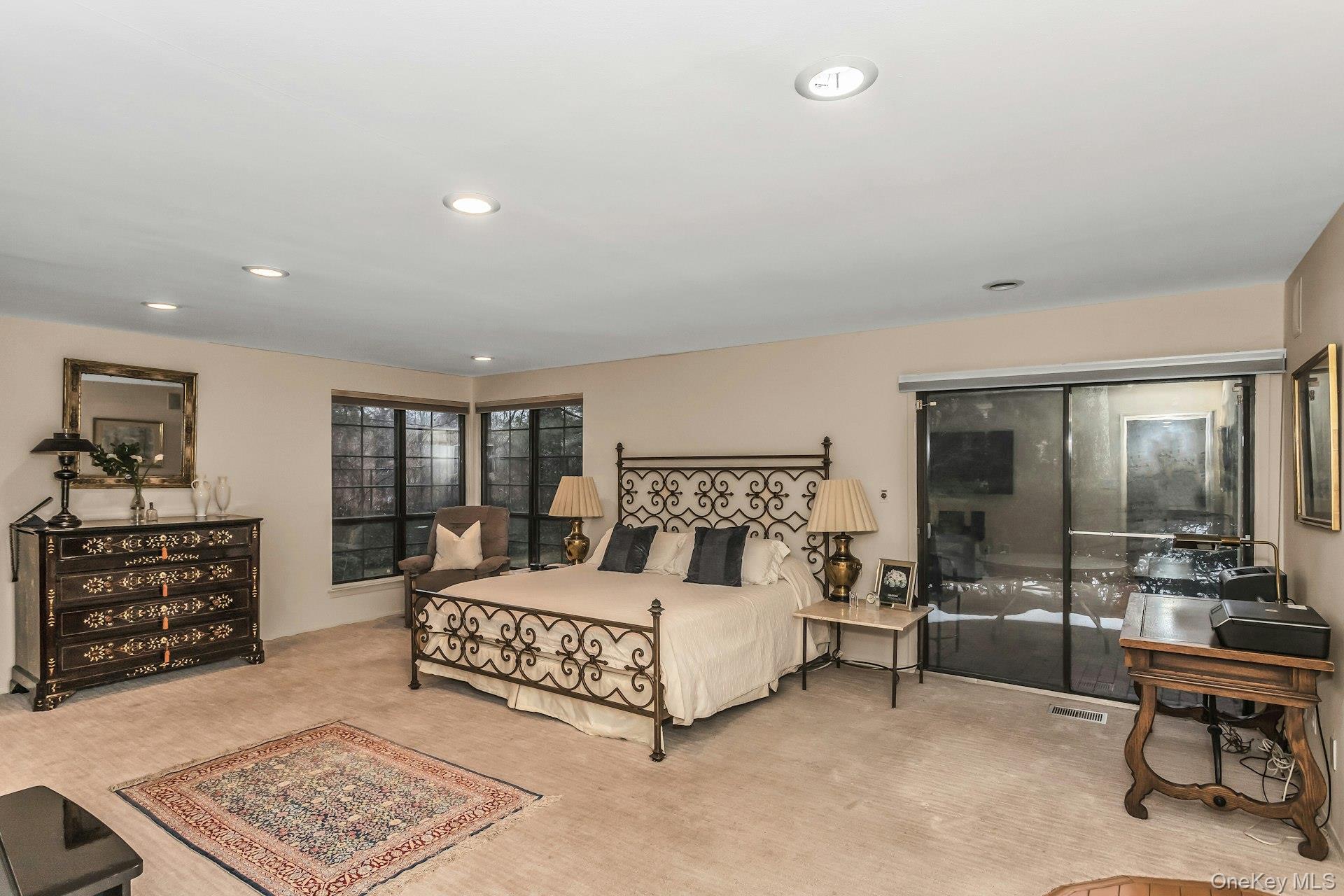 232 Linnet Court Manhasset, NY 11030 - Photo 10 of 28 a bedroom with a large bed and a table