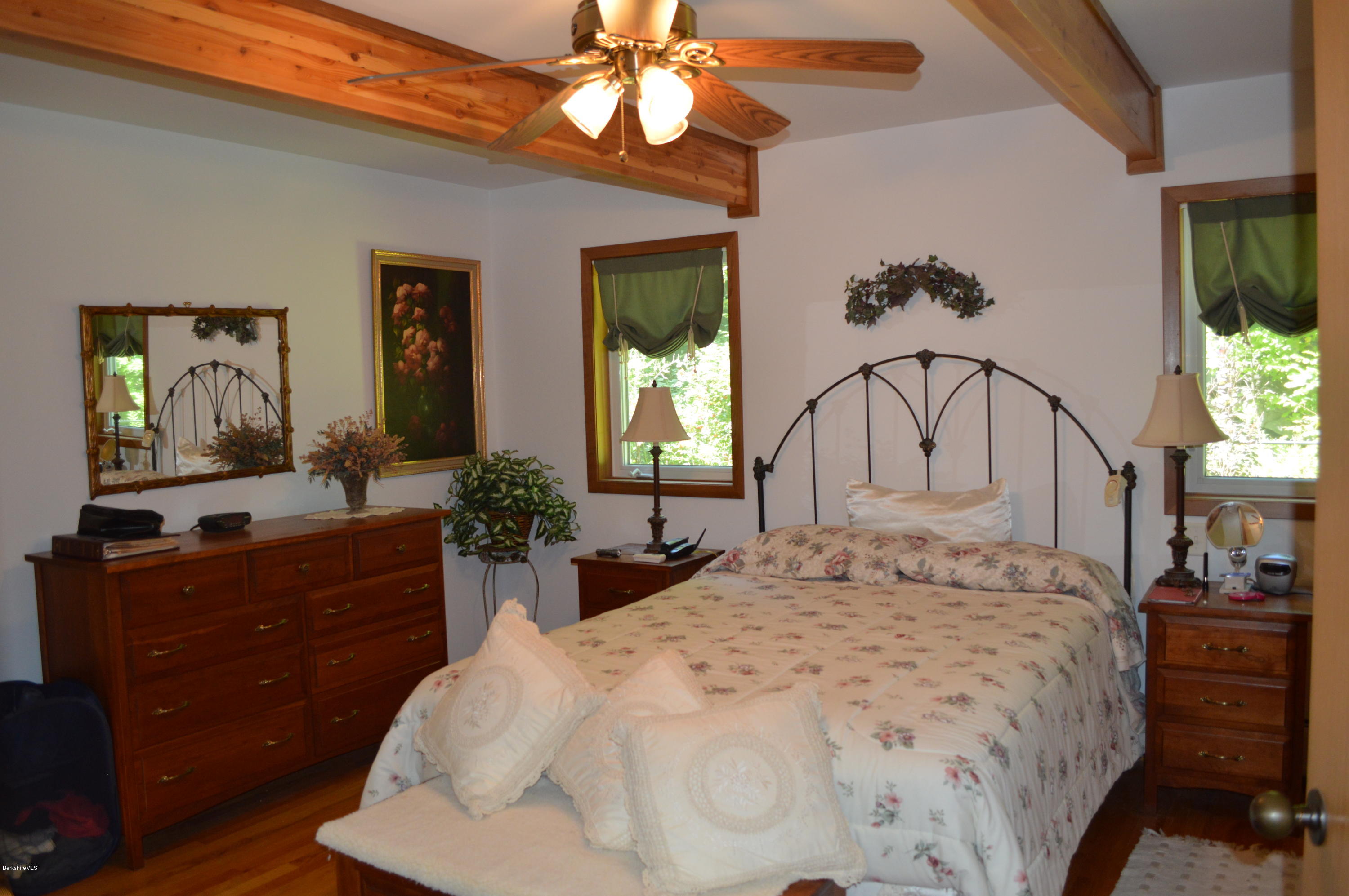 27 Reservoir Road Middlefield, MA 01235 - Photo 22 of 43 a bedroom with a large bed and a chandelier