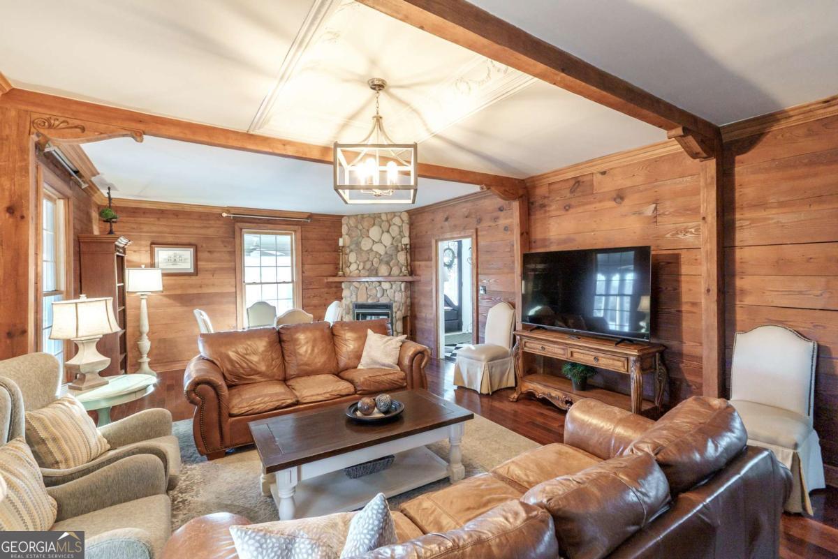 7527 Highway 326 Commerce, GA 30530 - Photo 23 of 100 a living room with furniture a flat screen tv and a chandelier