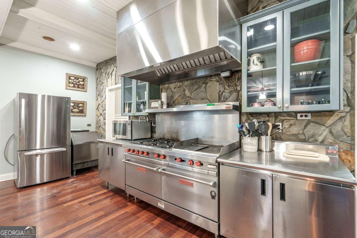 7527 Highway 326 Commerce, GA 30530 - Photo 51 of 100 a kitchen with stainless steel appliances granite countertop a stove and a refrigerator