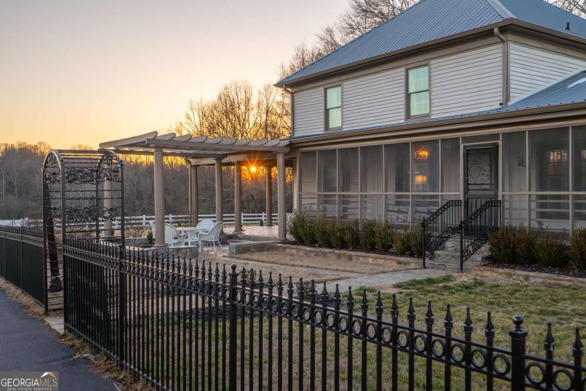 7527 Highway 326 Commerce, GA 30530 - Photo 95 of 100 a view of a house with a small yard and wooden fence