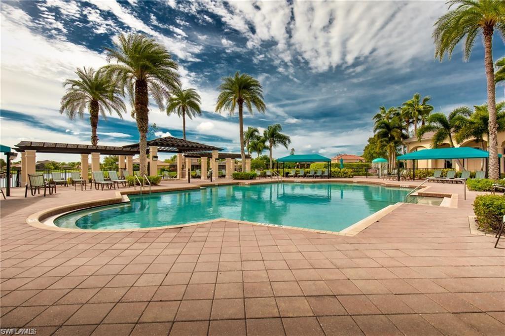 1415 Princess Sabal Point Naples, FL 34119 - Photo 37 of 42 Expansive swimming pool with integrated spa, surrounded by a paver deck