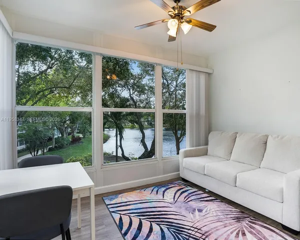 a living room with furniture and a large window