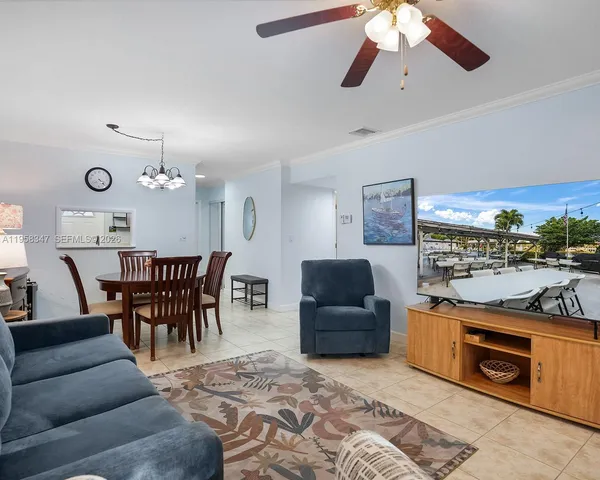 a living room with furniture a rug and a chandelier