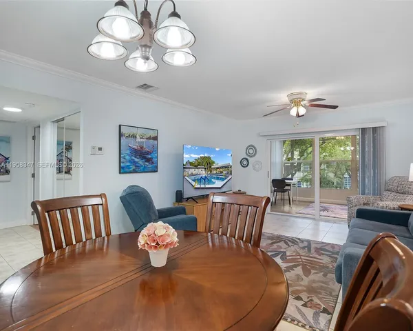 a bedroom with furniture and a large window