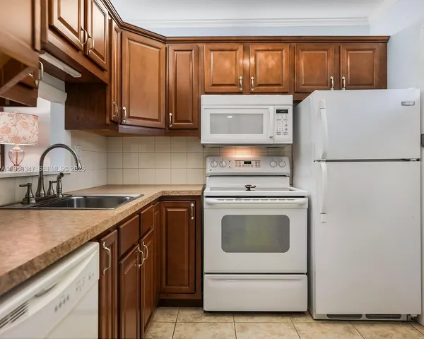 a kitchen with a white cabinets and white appliances