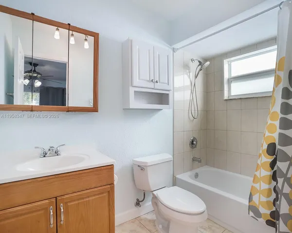 a bathroom with a sink a toilet and bathtub