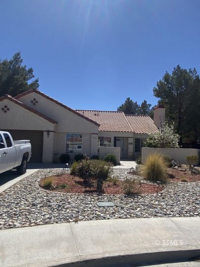 1233 Quail Way Ridgecrest, CA 93555 - Photo 3 of 6 a front view of a house with garden