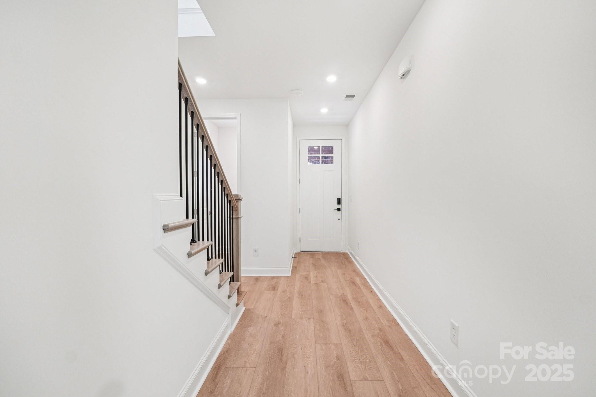 620 Mercury Drive Tega Cay, SC 29708 - Photo 2 of 16 a view of a hallway with wooden floor and stairs