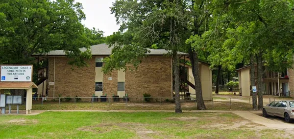 a view of a park with large trees