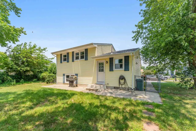 a front view of house with yard and trees