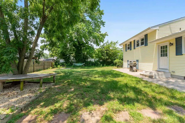 a view of a backyard with large trees
