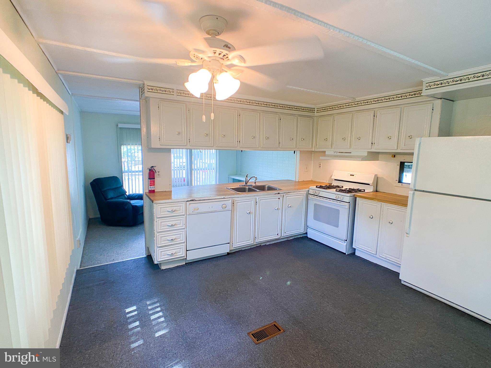 46 Jones Mill Road Wrightstown, NJ 08562 - Photo 7 of 34 a kitchen with stove cabinets and white appliances
