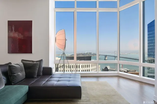 a bedroom with furniture and a large window