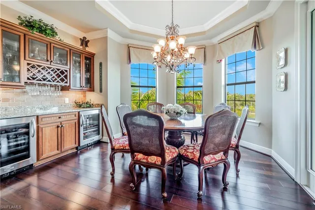 a view of a dining room with furniture wooden floor and chandelier