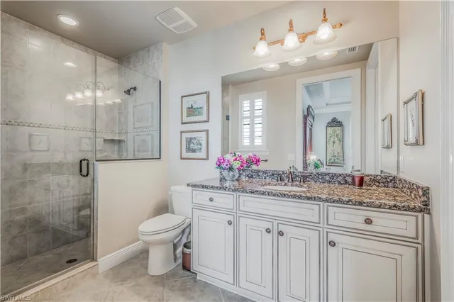 a bathroom with a sink vanity mirror and toilet