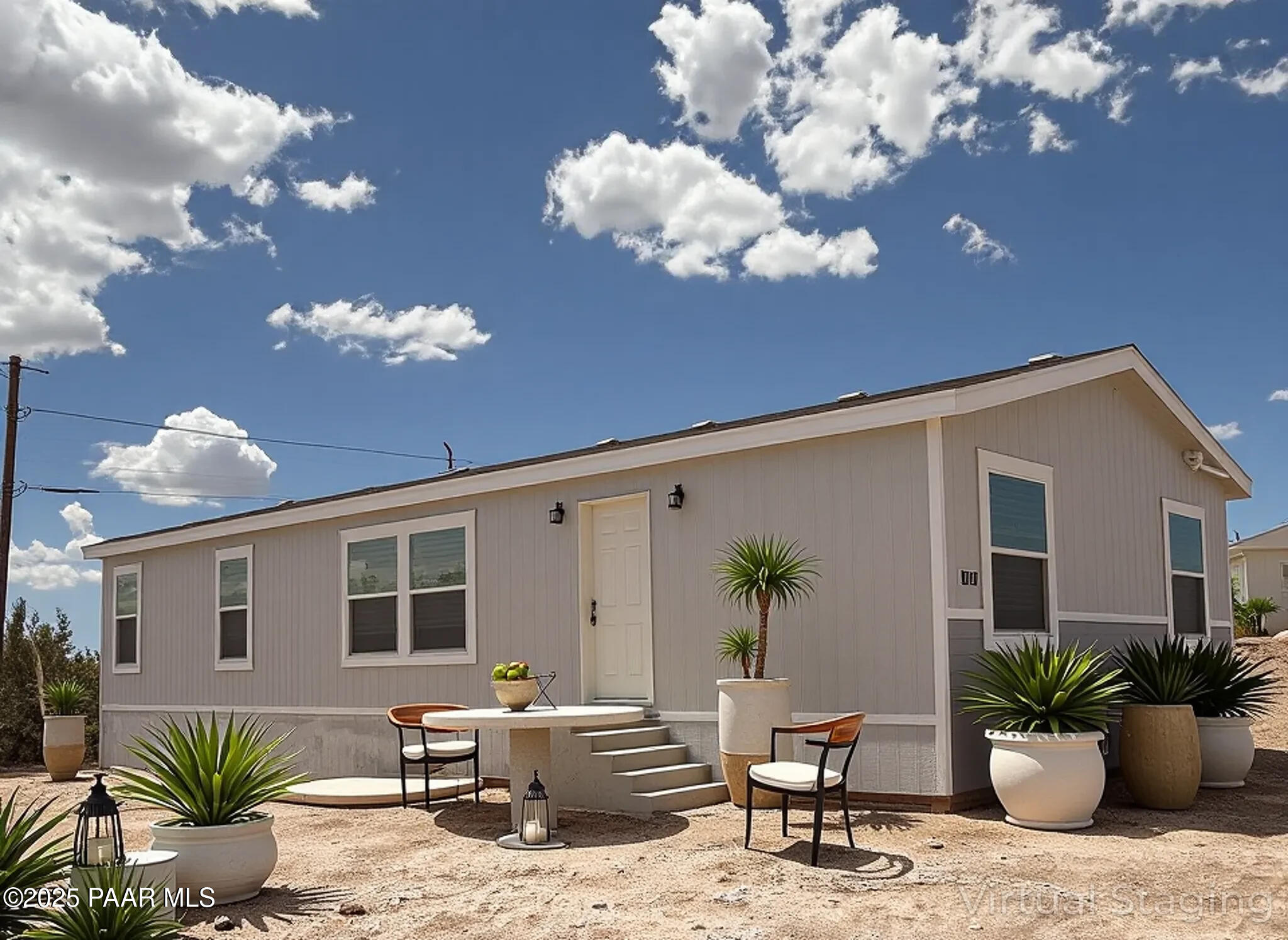 a view of a house with backyard and sitting area