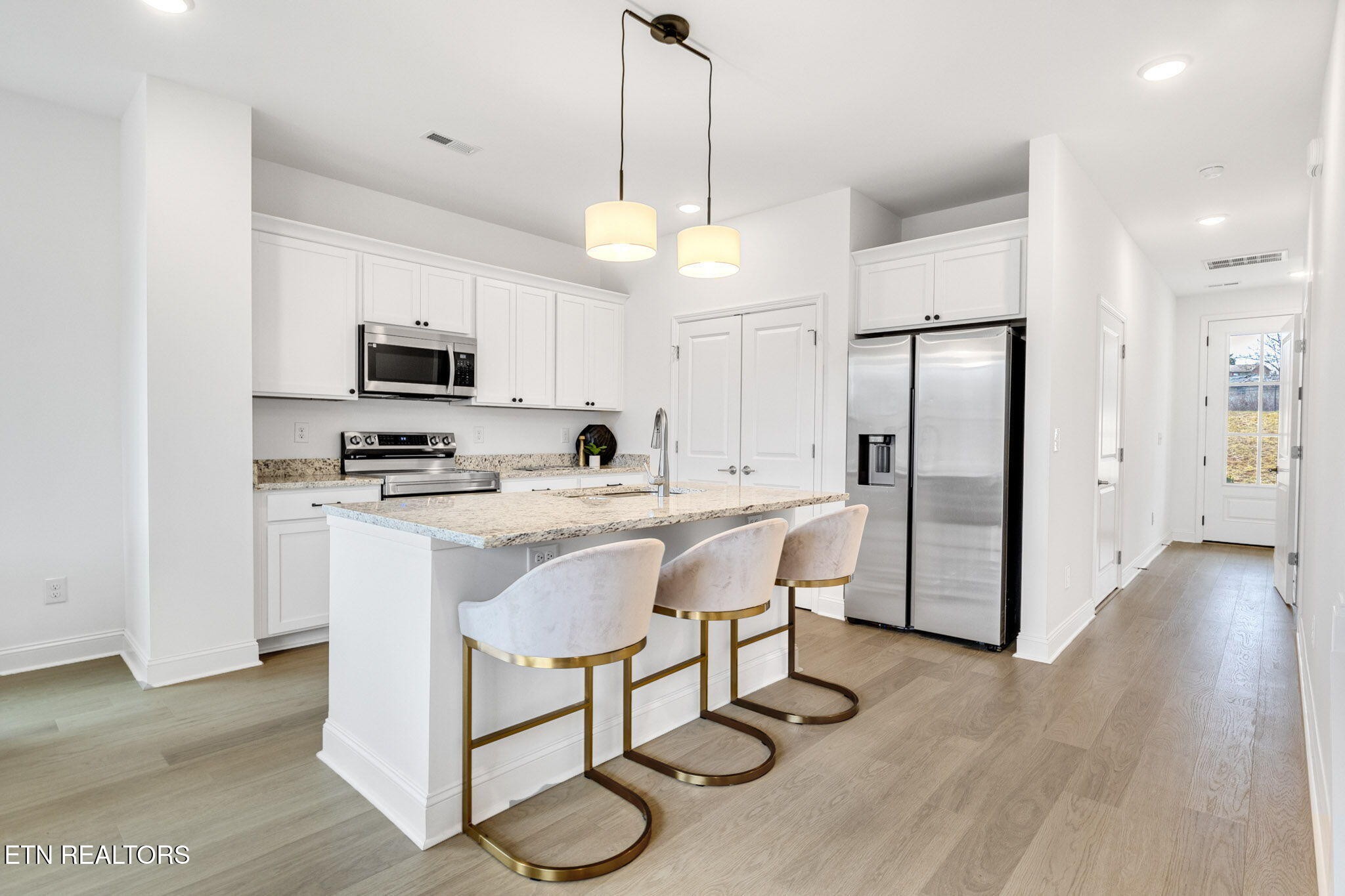 8418 Whisper Lane Powell, TN 37849 - Photo 11 of 42 a kitchen with stainless steel appliances a stove a refrigerator and microwave