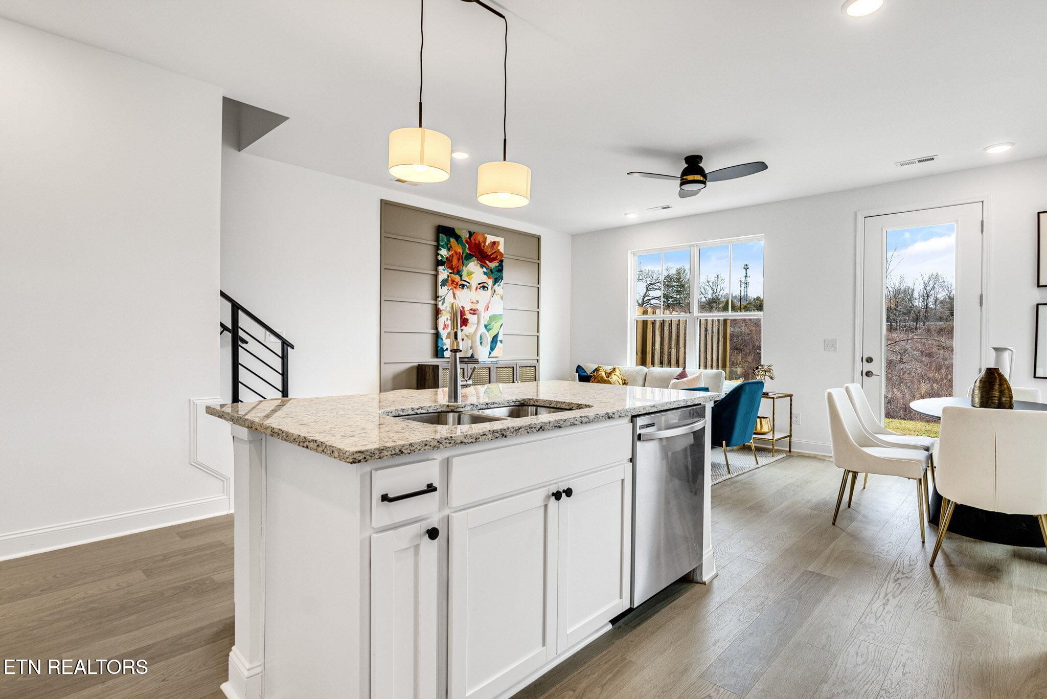 8418 Whisper Lane Powell, TN 37849 - Photo 12 of 42 a open kitchen with stainless steel appliances granite countertop a stove a sink dishwasher and a dining table with wooden floor