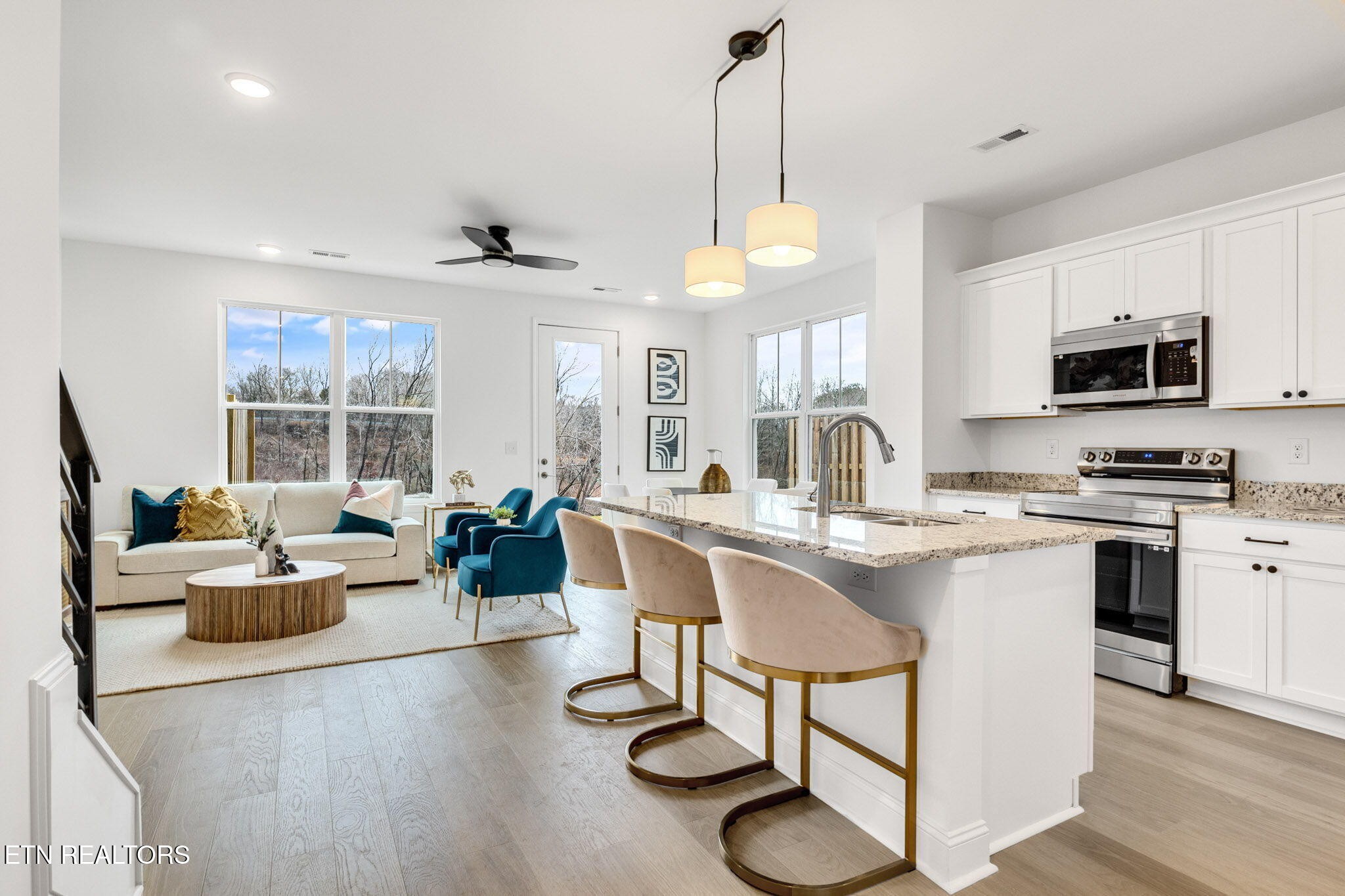 8418 Whisper Lane Powell, TN 37849 - Photo 15 of 42 a kitchen with stainless steel appliances granite countertop a stove a sink dishwasher a dining table and chairs with wooden floor