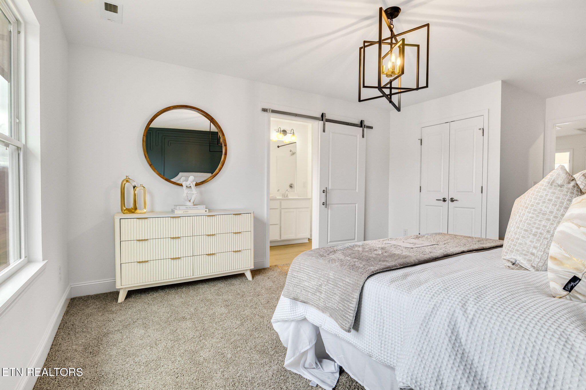 8418 Whisper Lane Powell, TN 37849 - Photo 20 of 42 a bedroom with a bed a chandelier and a dresser