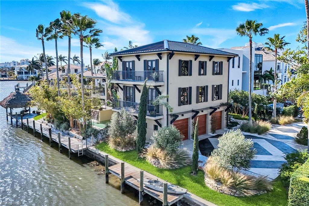 290 Channel Drive Naples, FL 34108 - Photo 12 of 49 a view of a house with backyard and sitting area