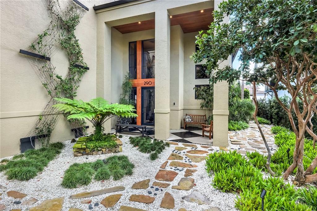 290 Channel Drive Naples, FL 34108 - Photo 13 of 49 a front view of a house with a yard