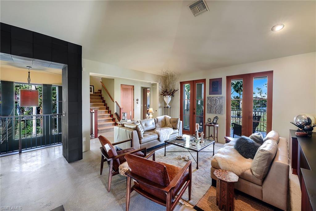290 Channel Drive Naples, FL 34108 - Photo 15 of 49 a living room with furniture a lamp and large window