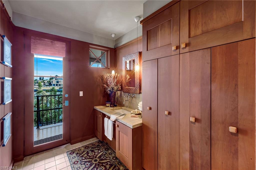 290 Channel Drive Naples, FL 34108 - Photo 22 of 49 a room with cabinets and wooden door