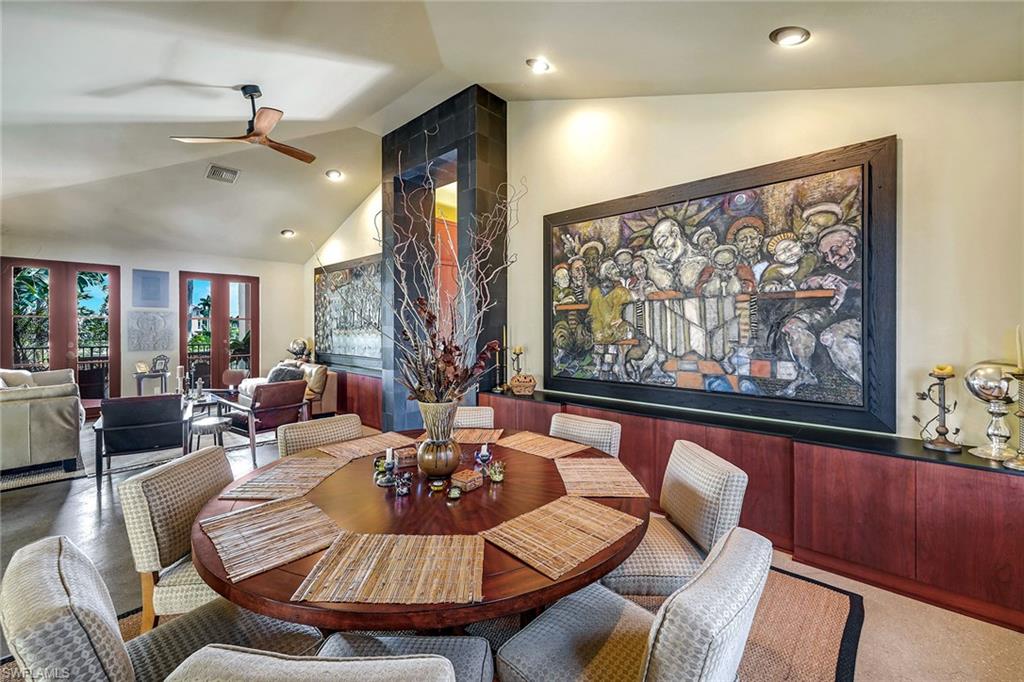 290 Channel Drive Naples, FL 34108 - Photo 25 of 49 a dining room with furniture a large window and wooden floor