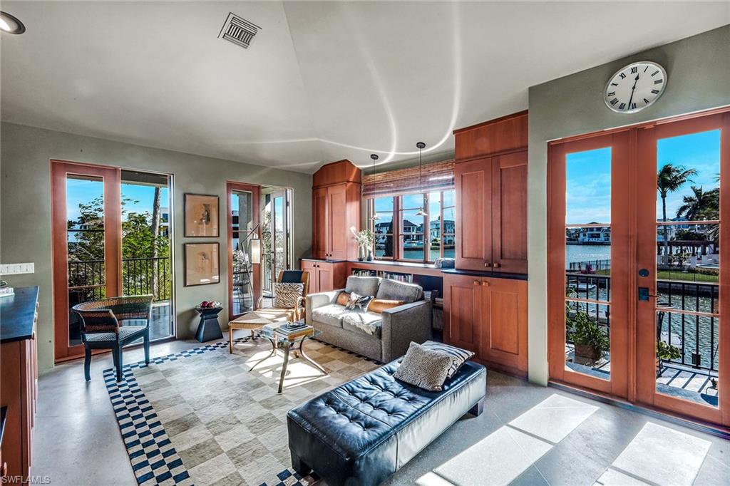 290 Channel Drive Naples, FL 34108 - Photo 26 of 49 a living room with furniture a bookshelf and a window
