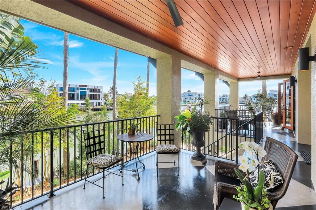 290 Channel Drive Naples, FL 34108 - Photo 32 of 49 a view of a chairs and table in patio