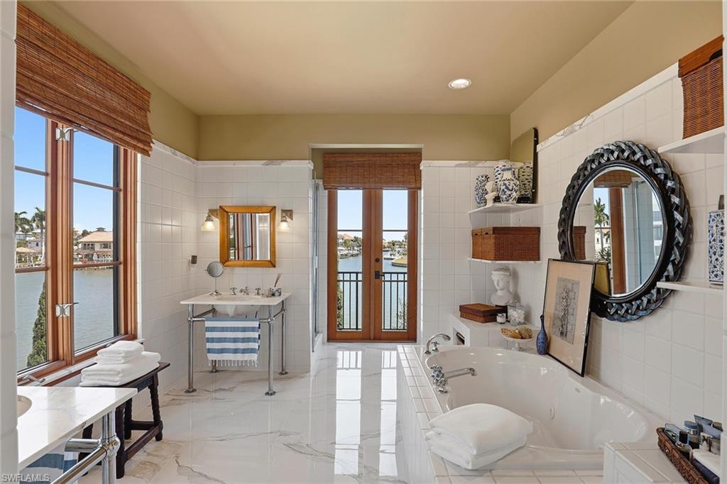 290 Channel Drive Naples, FL 34108 - Photo 32 of 45 a bedroom with furniture and a large window