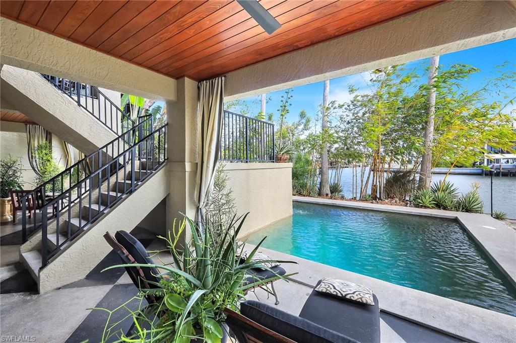 290 Channel Drive Naples, FL 34108 - Photo 37 of 49 a view of swimming pool with outdoor seating and plants