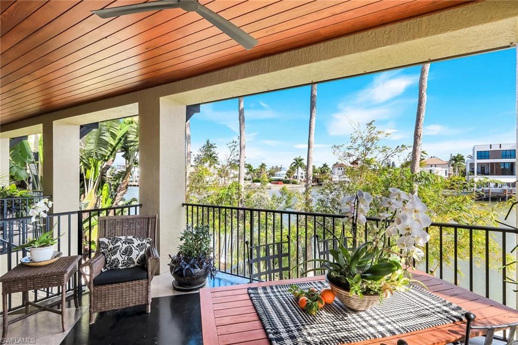290 Channel Drive Naples, FL 34108 - Photo 40 of 45 a balcony with furniture and wooden floor