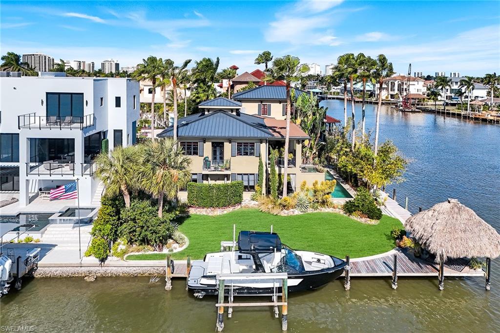 290 Channel Drive Naples, FL 34108 - Photo 40 of 49 a view of a lake with a table and chairs
