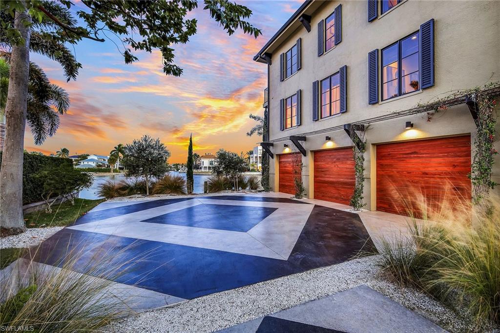 290 Channel Drive Naples, FL 34108 - Photo 41 of 49 a view of a swimming pool with a lounge chairs