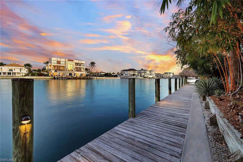 290 Channel Drive Naples, FL 34108 - Photo 42 of 49 a view of a lake with outside space