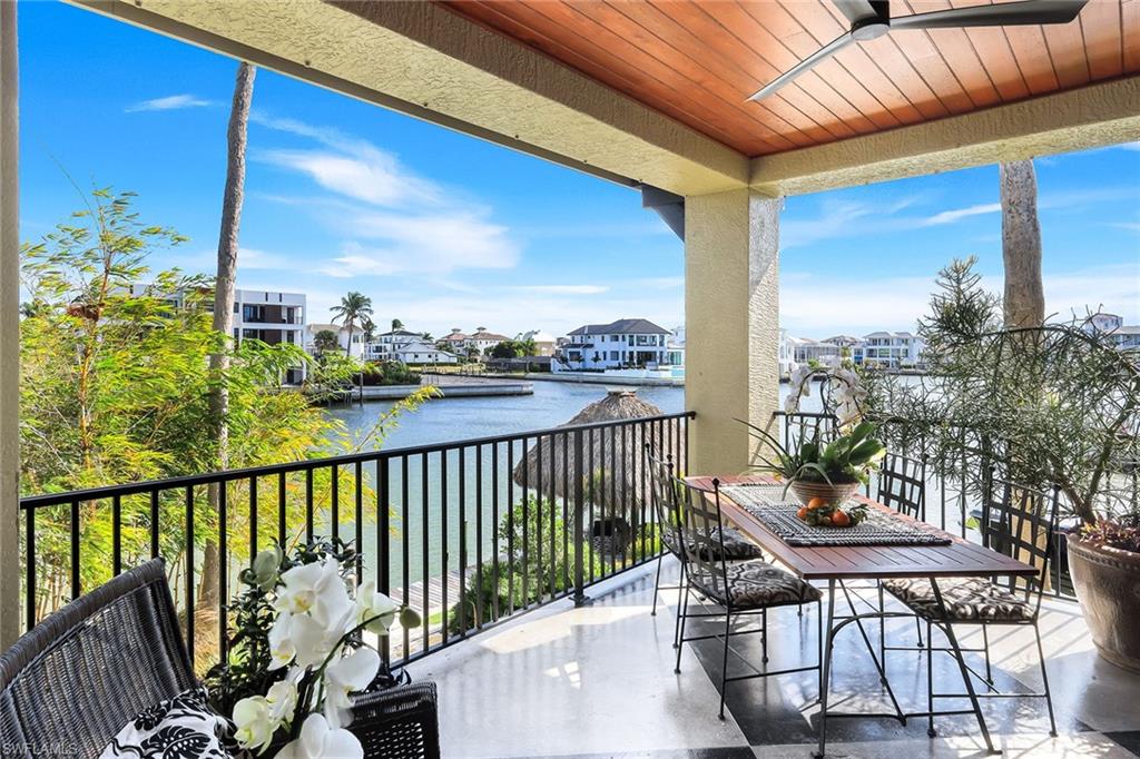 290 Channel Drive Naples, FL 34108 - Photo 43 of 45 a view of a balcony with chairs and wooden fence
