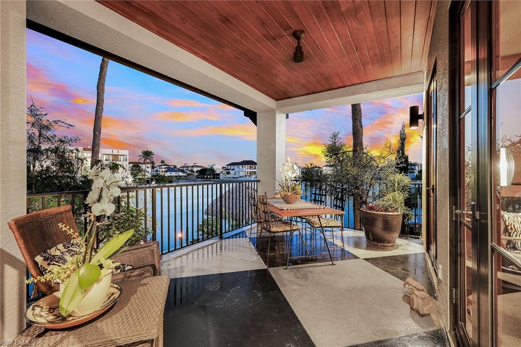 290 Channel Drive Naples, FL 34108 - Photo 45 of 49 a balcony with furniture and wooden floor