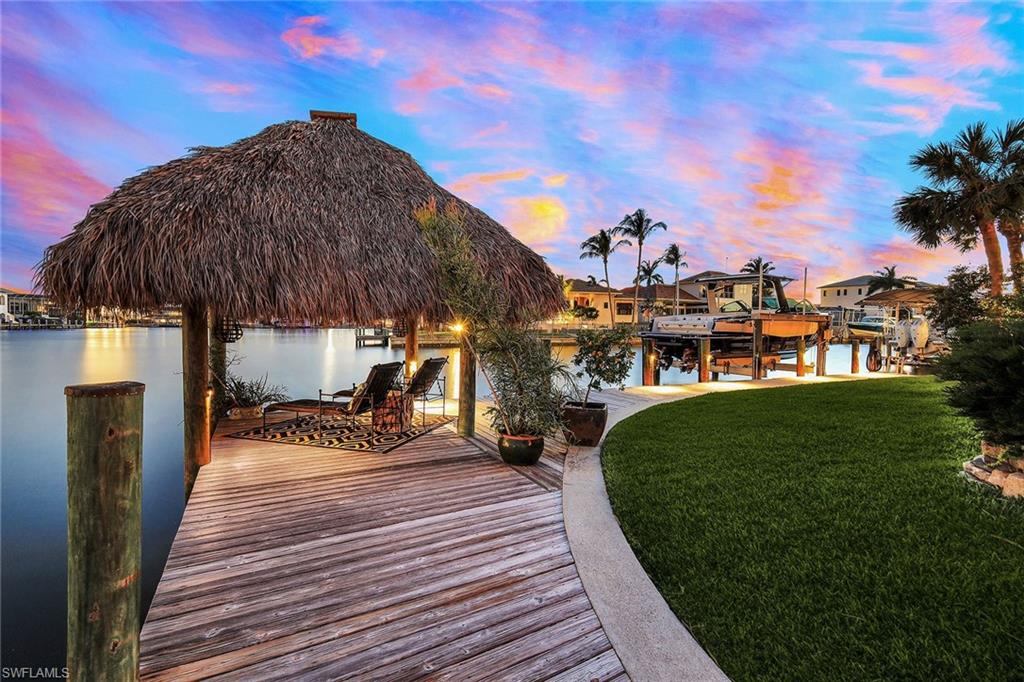 290 Channel Drive Naples, FL 34108 - Photo 46 of 49 a view of a swimming pool with a patio and a yard