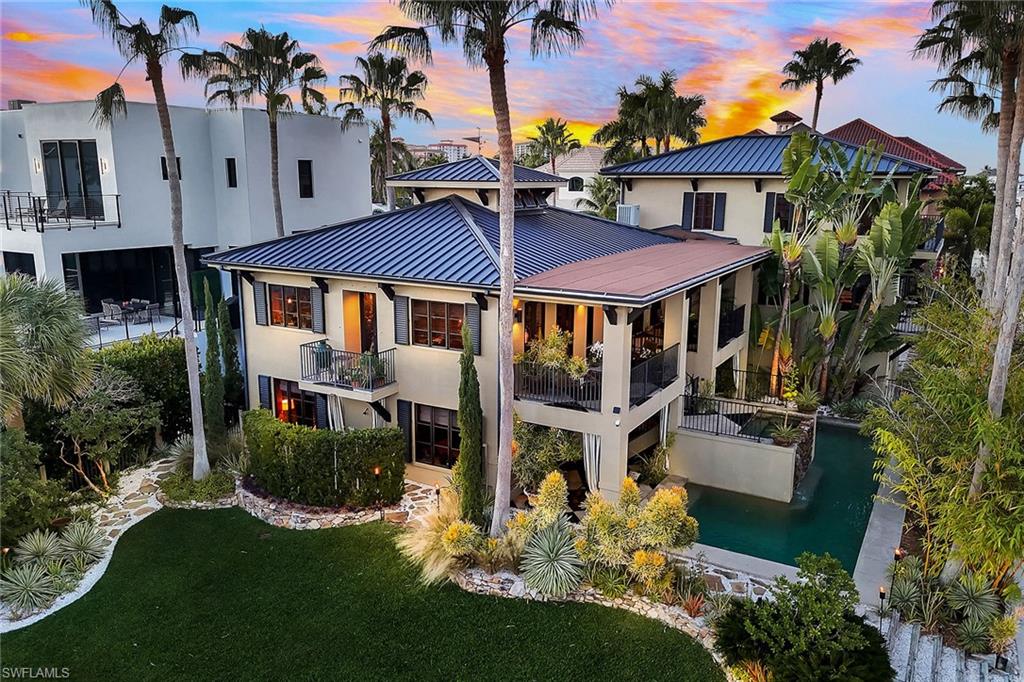 290 Channel Drive Naples, FL 34108 - Photo 47 of 49 a view of a house with a yard and sitting area
